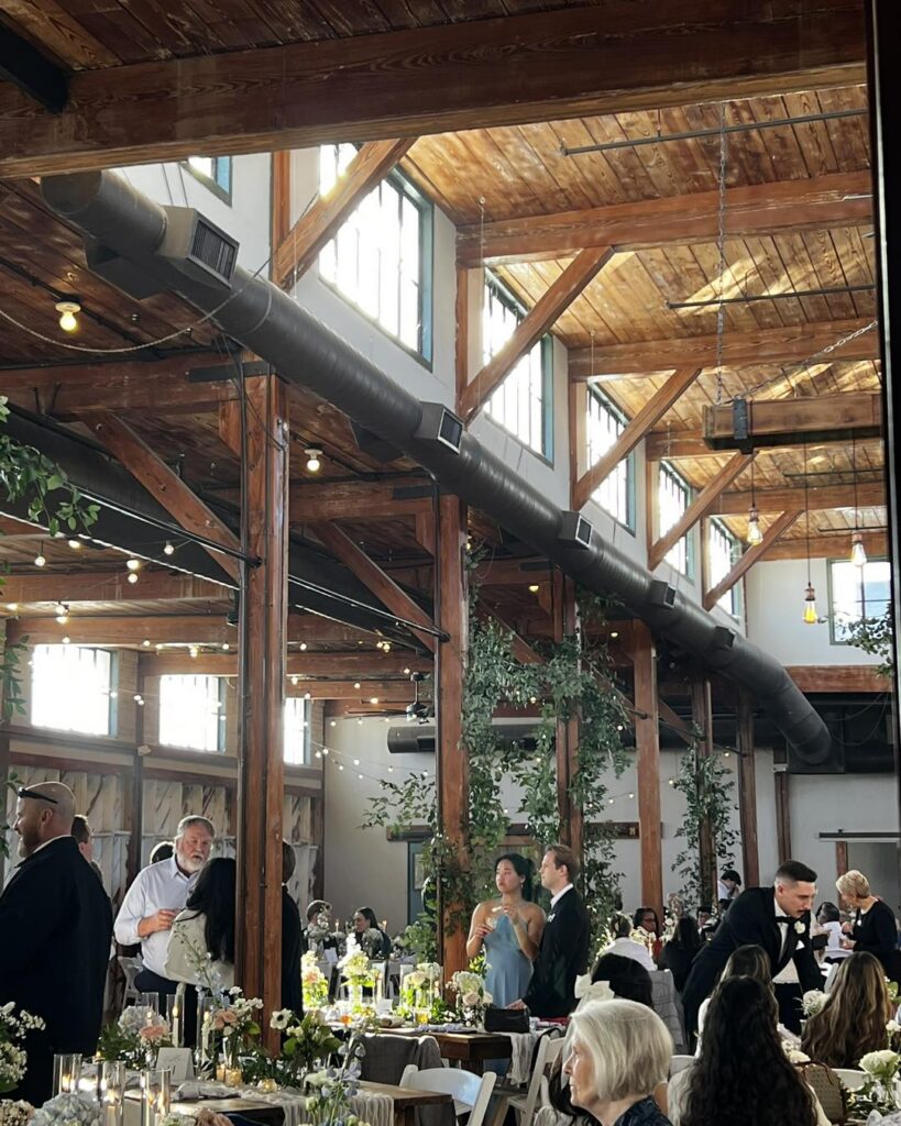 Detail shot of exposed brick and original hardwood beams — alt text: "Original 1914 brick and hardwood beams inside McKinney Flour Mill event hall